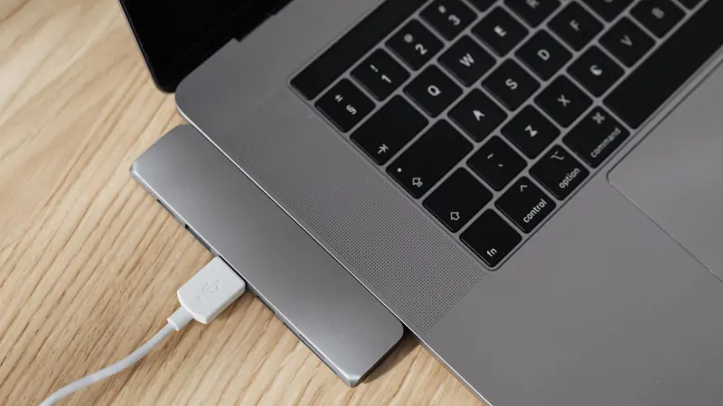 Laptop with a USB hub on a wooden desk